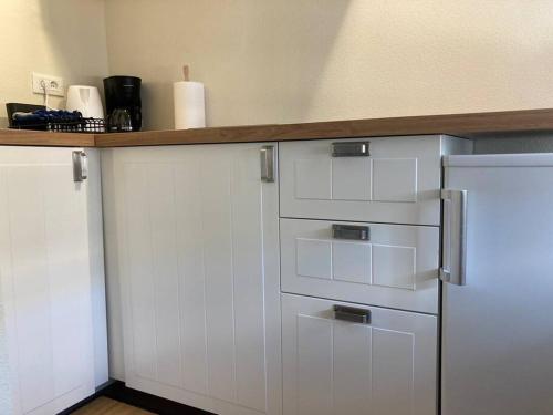 a kitchen with white cabinets and a counter top at Studio Nina in Umag