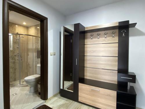 a bathroom with a toilet and a glass shower stall at PARADISO 402 Private Apartment Nessebar in Nesebar