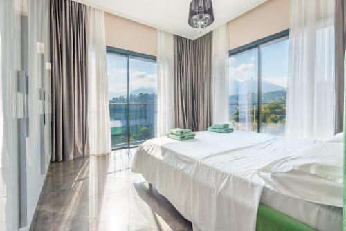 a bedroom with a bed and a large window at Villa Daniel in Menton