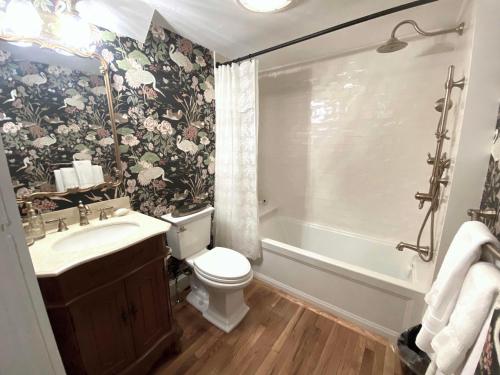 a bathroom with a toilet and a sink and a tub at Silsbee's by Daniels House in Salem