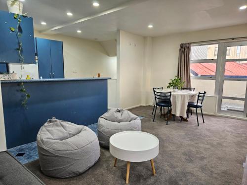 a living room with a table and chairs at 4 Bedrooms, VERY Central Townhouse! in Wellington
