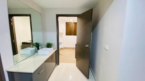 a bathroom with a sink and a mirror at Lovely 4-bedroom Holiday home with free parking. in Lautoka