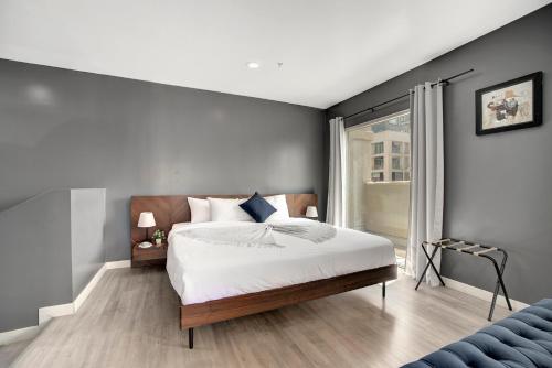 a bedroom with a large bed and a window at Good Hotels Downtown Denver in Denver