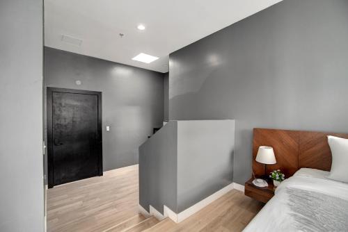 a bedroom with a bed and a black door at Good Hotels Downtown Denver in Denver