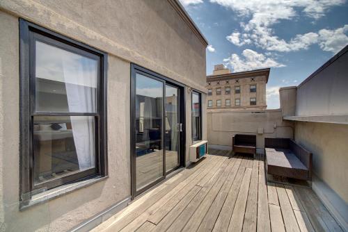 a balcony of a building with a wooden deck at Good Hotels Downtown Denver in Denver