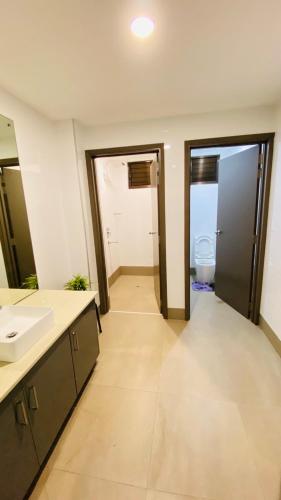 a bathroom with a sink and a toilet at Lovely 4-bedroom Holiday home with free parking. in Lautoka