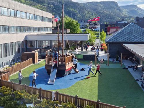 a group of people playing on a playground in a building at Bremanger Fjord Hotell in Svelgen