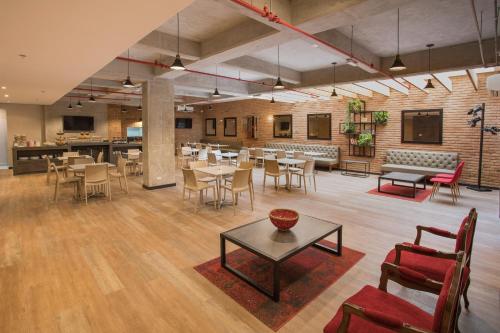 a restaurant with tables and chairs in a room at Hotel Quinta Norte Chipichape in Cali