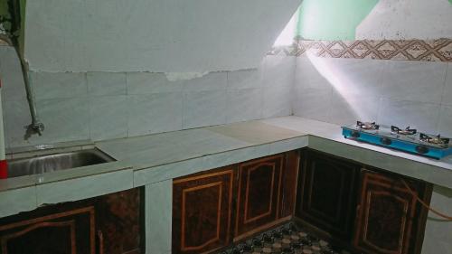 a kitchen with a sink and a counter top at Summer and winter homestay Turtuk Youl in Turtok