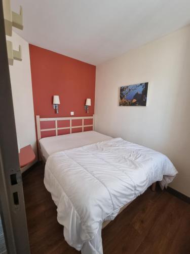 une chambre avec un grand lit avec des draps blancs dans l'établissement Village Cap Esterel, P2 face golf et mer, à Agay