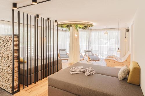 a living room with a couch and chairs at Apartments Silva Timeout in San Giovanni in Val Aurina