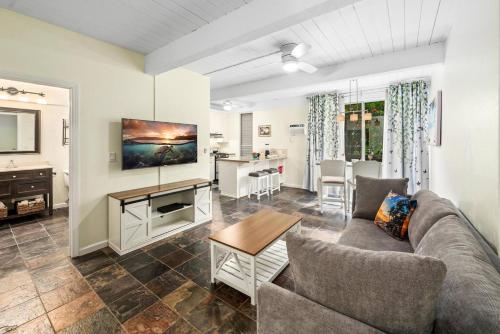 a living room with a couch and a table at Kona Mansions by Casago Kona - Condo C-108 in Kailua-Kona