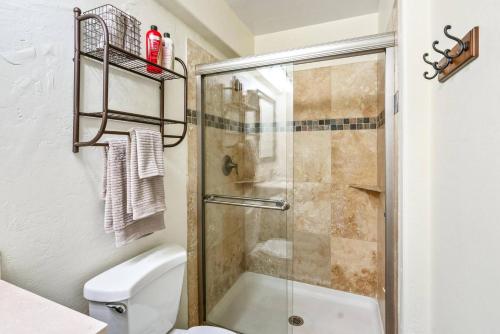 a bathroom with a shower and a toilet at Kona Mansions by Casago Kona - Condo C-108 in Kailua-Kona