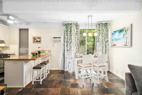 a kitchen and dining room with a table and chairs at Kona Mansions by Casago Kona - Condo C-108 in Kailua-Kona