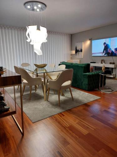 a living room with a table and a green couch at Appartement en face de la mer in Azurara