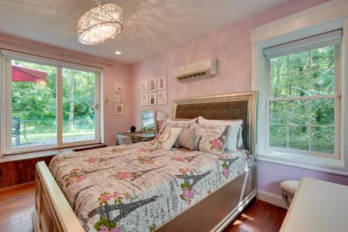 a bedroom with a bed and two windows at Large Family Home with Patios, Gas Grill and Fire Pit! in Delaware