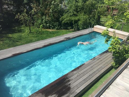 eine Person, die in einem Pool schwimmt in der Unterkunft Ferienwohnung Rheinblick, ruhig, Aussicht, Gartennutzung, Sport-Pool in Koblenz