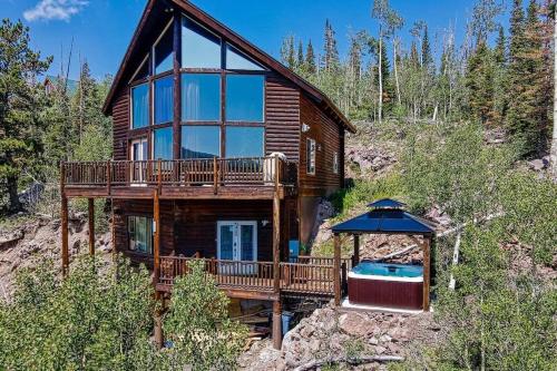 a log cabin with a swimming pool and a house at Spectacular Chalet overlooking the ski slopes in Brian Head