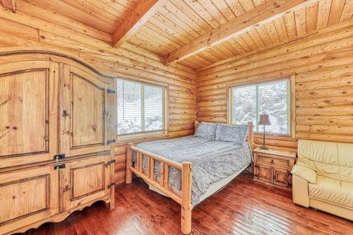 a bedroom with a bed in a log cabin at Spectacular Chalet overlooking the ski slopes in Brian Head