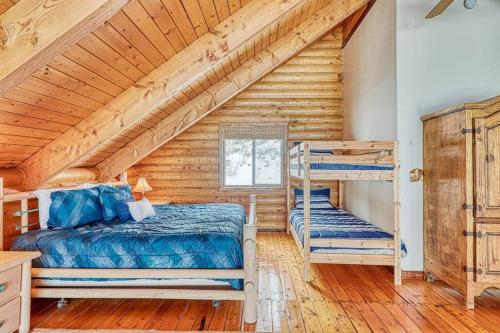 a bedroom with two bunk beds in a log cabin at Spectacular Chalet overlooking the ski slopes in Brian Head