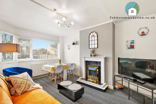 a living room with a table and a fireplace at Private 2Bed-Parking & Garden-By FabAccommodation in Bristol