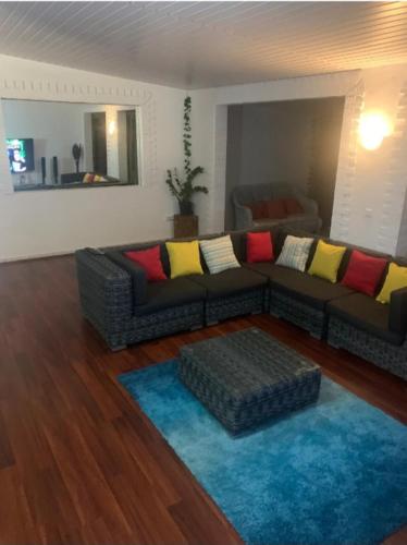 salon z kanapą i niebieskim dywanem w obiekcie Pacific Lodge w mieście Mahina