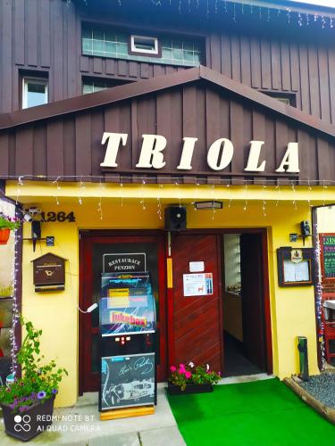 a pizza store with a ticket machine in front of it at WELLNESS Penzion Triola in Kořenov