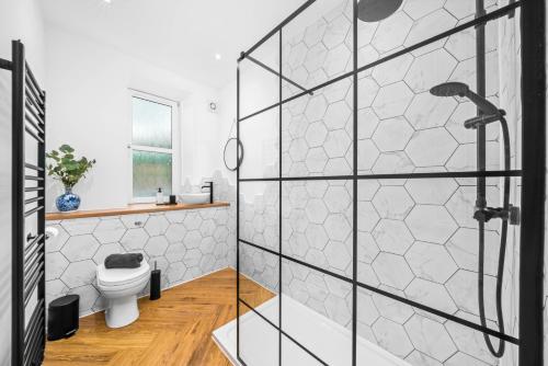 a bathroom with a shower and a toilet at Stylish 4 Bed-Town Centre in Galashiels