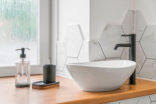 a white sink and a bottle on a wooden counter at Stylish 4 Bed-Town Centre in Galashiels