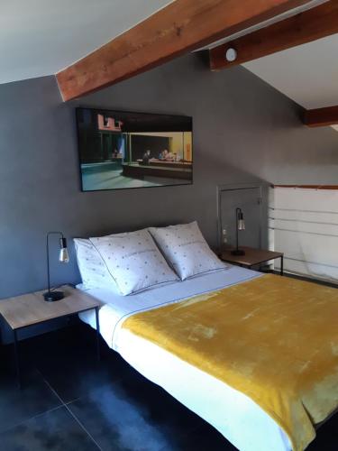 a bedroom with a large bed with two tables and a mirror at Maison de vacances à Pégomas avec piscine - 3 chambres - 5 personnes - Jardin et parking privatif in Pégomas