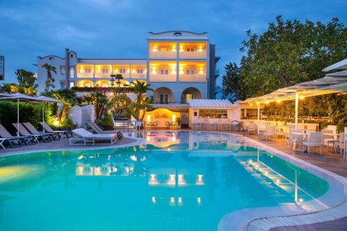 a pool in front of a hotel at night at Hermitage Resort & Thermal Spa in Ischia