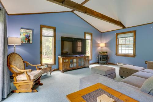 a living room with a couch and a tv at 1 Mi to River Cabin with Fire Pit in Milanville! in Milanville