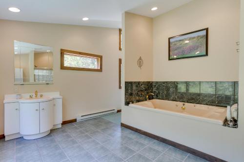 a bathroom with a tub and a sink at 1 Mi to River Cabin with Fire Pit in Milanville! in Milanville