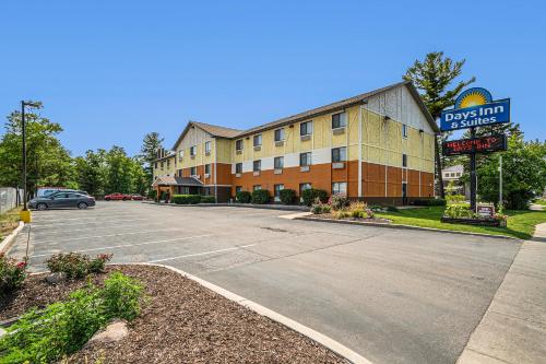 an empty parking lot in front of a hotel at Days Inn & Suites by Wyndham Traverse City in Traverse City