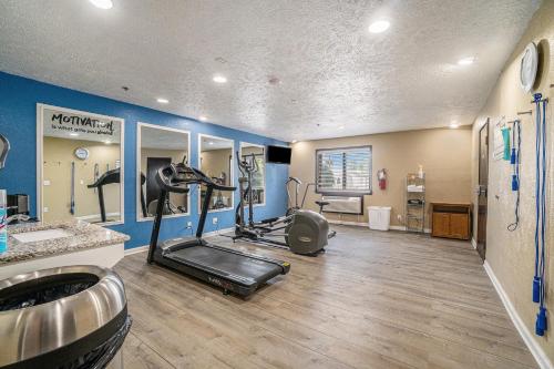 a gym with a treadmill and ellipticals in a room at Days Inn & Suites by Wyndham Traverse City in Traverse City