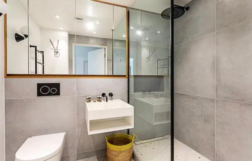 a bathroom with a toilet and a sink and a shower at Penthouse in Luton