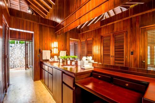 a large bathroom with wooden walls and a sink at Sunny Vacation Villa No 35 in San Rafael del Yuma