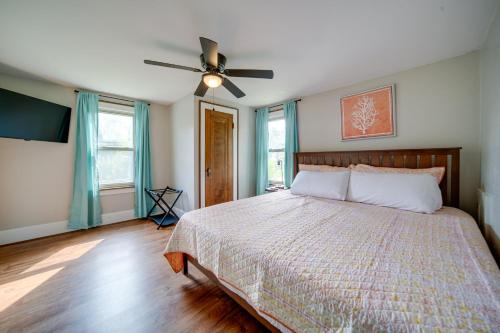 a bedroom with a bed and a ceiling fan at Central Erie Vacation Rental about 2 Mi to Beach! in Erie
