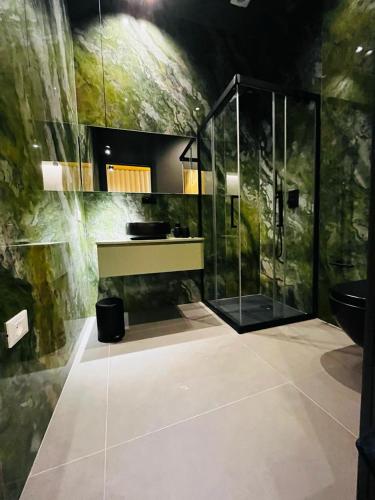 a bathroom with a glass shower and a toilet at Rosy Room Design in Marsala