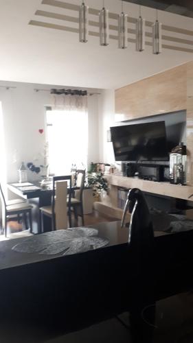 a living room with a kitchen and a dining room at Apartament nad jeziorem w Brodnicy in Brodnica