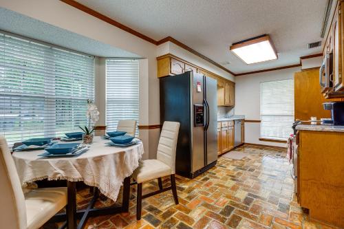 a kitchen with a table and a refrigerator at Dog-Friendly Alabama Retreat with Patio and Fire Pit! in Semmes