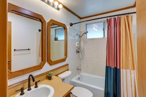 a bathroom with a sink and a toilet and a tub at Rimforest Retreat with Fireplace and Mountain Views! in Rimforest