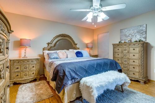 a bedroom with a bed and two dressers and a ceiling fan at Dog-Friendly Alabama Retreat with Patio and Fire Pit! in Semmes