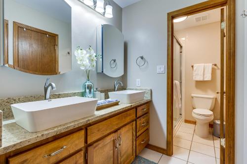 a bathroom with two sinks and a toilet at Dog-Friendly Alabama Retreat with Patio and Fire Pit! in Semmes