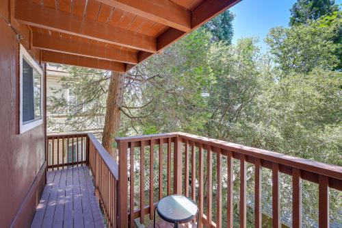 a balcony of a cabin with a table on it at Rimforest Retreat with Fireplace and Mountain Views! in Rimforest
