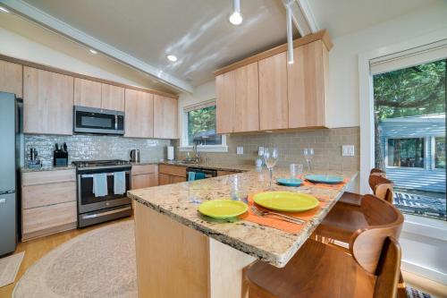 a kitchen with a table with two yellow plates on it at Higgins Lake House with Swimming Dock! in Roscommon