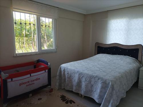 a small bedroom with a bed and a window at Denize 3km Daire - Piraziz Giresun in Giresun