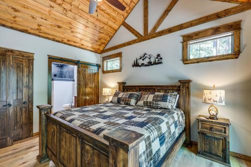 a bedroom with a bed and a wooden ceiling at Big Cedar Vacation Rental with Deck and Hot Tub! in Hodgen