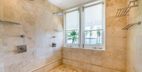 a bathroom with a shower and a window at Sunny Vacation Villa No 37 in San Rafael del Yuma