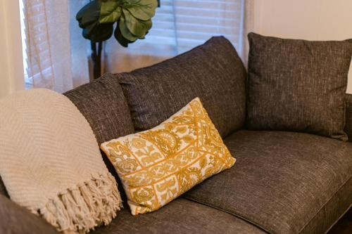 a brown couch with a pillow on it at Waterfront River Apartments in Rogue River